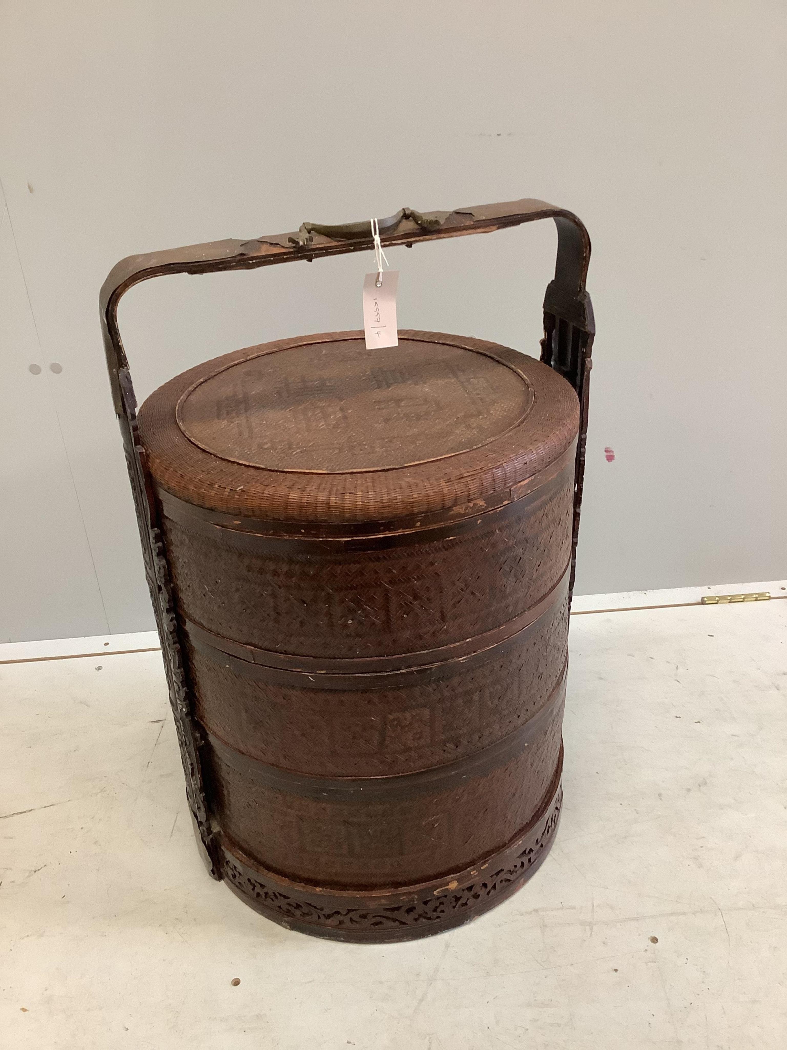 A Chinese carved wood and rattan wedding basket, width 48cm, height 71cm. Condition - fair to good